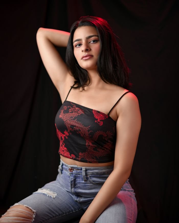 Contact A stylish portrait of a woman in a studio setting showcasing modern fashion.