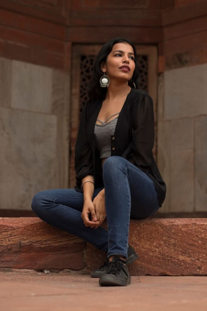 Home Young South Asian woman posing elegantly at a historical site in New Delhi.