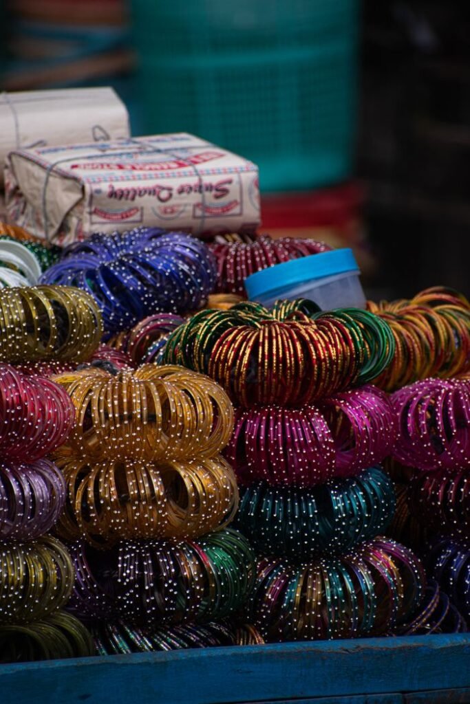 Menu Colorful Indian bangles stacked at a market stall, showcasing traditional fashion.